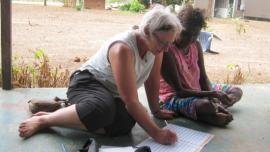 Frances Morphy sitting with an Aboriginal woman of Australia to help with her legal case