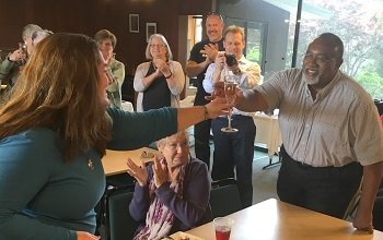 CASBS fellow Rose McDermott toasts Glenn Loury | Photo by Howard Morphy