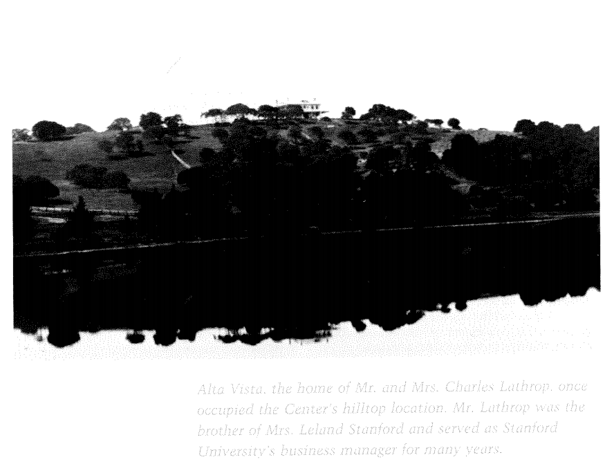 A hill with a house on it being reflected in the water